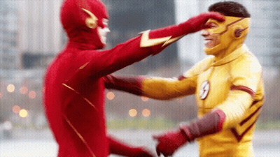 A Man In A Flash Costume Is Touching Another Man 'S Face GIF
