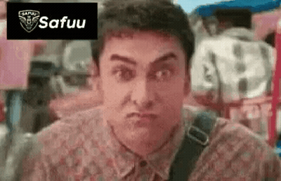 A Man In A Floral Shirt Is Making A Funny Face With His Mouth Open . GIF