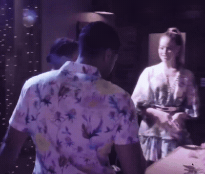 A Man In A Floral Shirt Is Standing Next To A Woman In A Kimono GIF