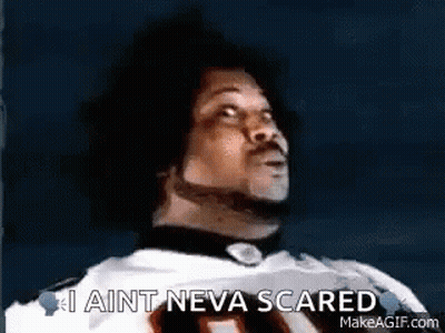 A Man In A Football Jersey Is Looking Up And Saying `` I Ain T Neva Scared '' . GIF