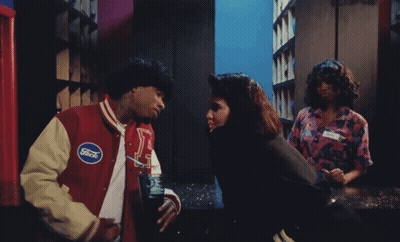 A Man In A Ford Jacket Talks To A Woman In A Pink Shirt GIF