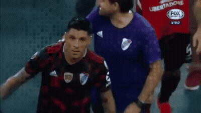 A Man In A Fox Sports Shirt Stands Next To A Man In A Purple Shirt GIF