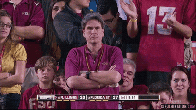 A Man In A Fsu Shirt Stands In The Crowd GIF