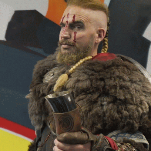 A Man In A Fur Coat Is Holding A Mug With A Circle On It GIF