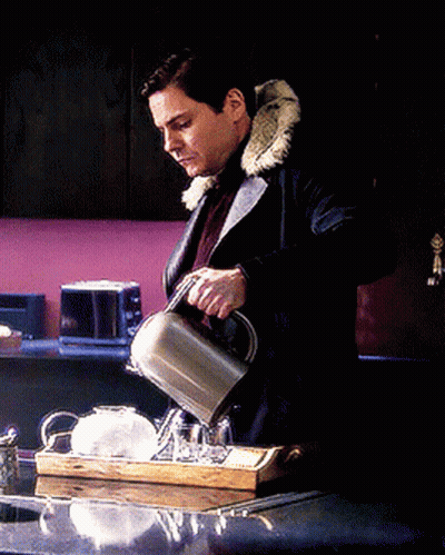 A Man In A Fur Coat Is Pouring Tea Into A Cup On A Tray GIF