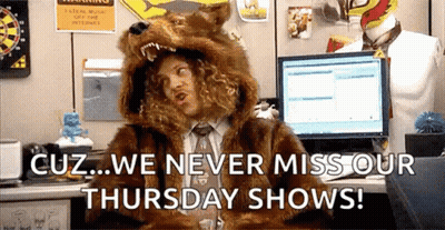A Man In A Fur Coat Is Sitting At A Desk With A Computer . GIF