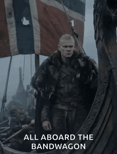 A Man In A Fur Coat Is Standing On A Boat With The Words " All Aboard The Bandwagon " Below Him GIF