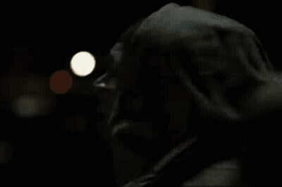 A Man In A Fur Coat Is Talking On A Cell Phone . GIF