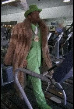 A Man In A Fur Coat Is Walking On A Treadmill GIF