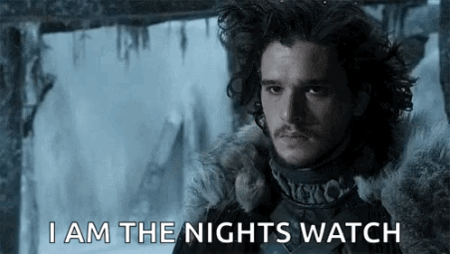 A Man In A Fur Coat Says `` I Am The Nights Watch '' While Standing In Front Of A Frozen Waterfall . GIF