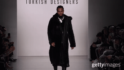 A Man In A Fur Coat Walks Down A Runway At A Turkish Designer 'S Fashion Show GIF