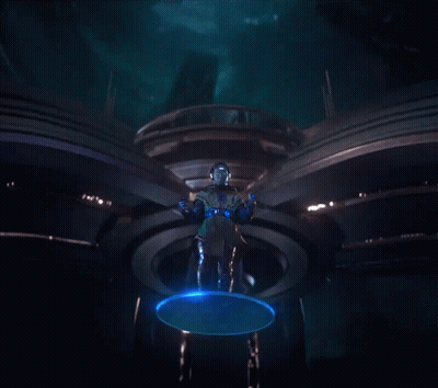 A Man In A Futuristic Costume Is Standing In A Dark Room GIF