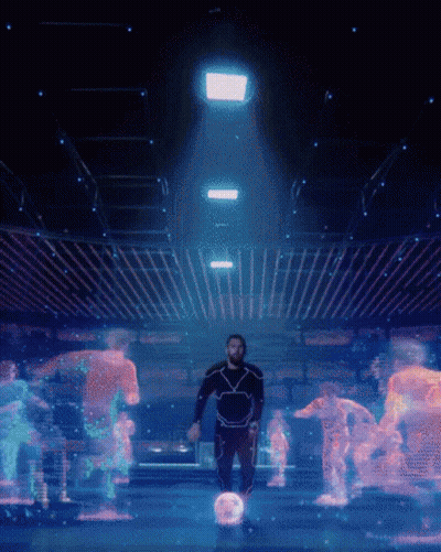 A Man In A Futuristic Suit Is Surrounded By Glowing Robots GIF