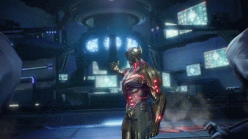 A Man In A Futuristic Suit Stands In A Room With A Lot Of Monitors GIF
