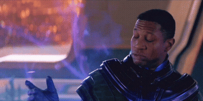 A Man In A Futuristic Suit With His Eyes Closed And His Hands Outstretched GIF