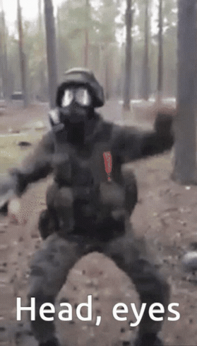 A Man In A Gas Mask Is Dancing In The Woods With The Words Head Eyes Written Below Him GIF