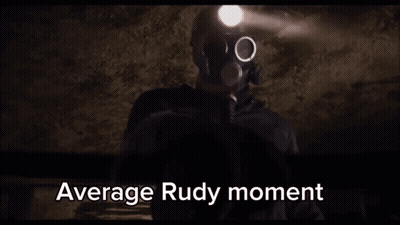 A Man In A Gas Mask Is Holding A Flashlight In A Dark Room With The Words Average Rudy Moment Written Below Him . GIF