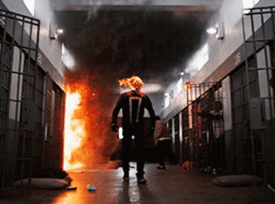 A Man In A Ghost Rider Costume Walks Through A Prison GIF