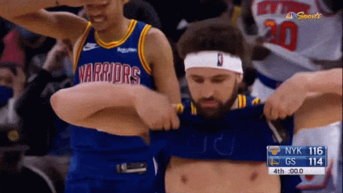 A Man In A Golden State Warriors Jersey Is Being Held By Another Man GIF