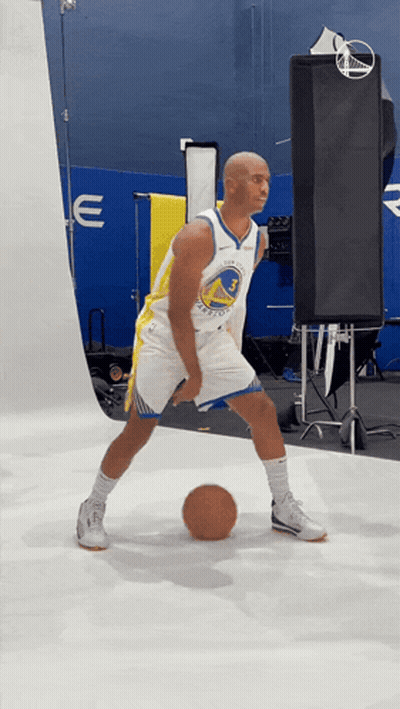 A Man In A Golden State Warriors Jersey Is Dribbling A Ball GIF