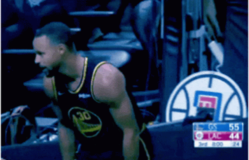 A Man In A Golden State Warriors Jersey Stands In The Stands During A Basketball Game GIF