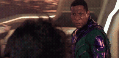 A Man In A Green And Purple Jacket Is Standing Next To Another Man In A Purple Jacket . GIF