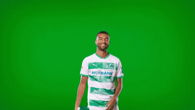 A Man In A Green And White Shirt With The Word Homann On The Front GIF