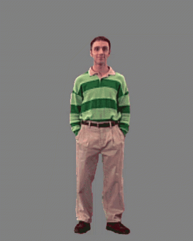 A Man In A Green And White Striped Shirt Is Standing Next To A Bunny Costume GIF