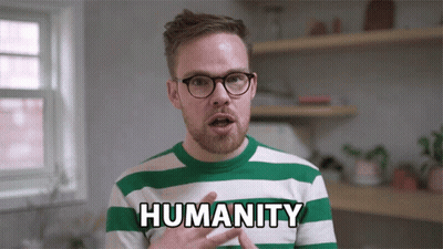A Man In A Green And White Striped Shirt With The Word Humanity On It GIF