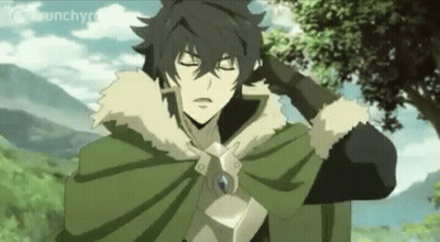 A Man In A Green Cape Is Standing In A Field With His Eyes Closed . GIF