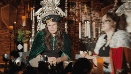 A Man In A Green Cape Sits On A Throne In Front Of A Bottle Of Hendrick 'S Gin GIF