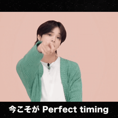 A Man In A Green Cardigan Is Pointing At The Camera With The Words Perfect Timing Written Below Him GIF