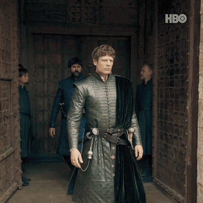 A Man In A Green Coat Stands In Front Of A Door With Hbo Written On It GIF