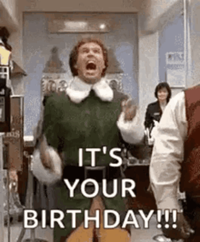 A Man In A Green Elf Costume Is Shouting It 'S Your Birthday While Holding A Guitar In A Room . GIF