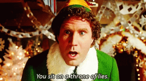 A Man In A Green Elf Costume Is Sitting On A Throne Of Lies In Front Of A Christmas Tree . GIF