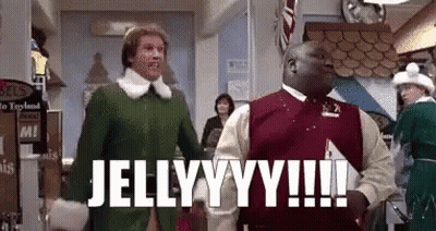 A Man In A Green Elf Costume Is Standing Next To A Man In A Red Sweater In A Store . GIF