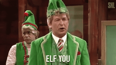 A Man In A Green Elf Costume Is Standing Next To Another Man In A Green Elf Costume . GIF