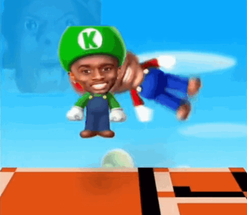 A Man In A Green Hat With The Letter K On It Is Playing A Video Game GIF
