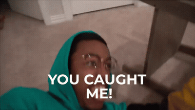 A Man In A Green Hoodie Is Laying On The Floor With The Words You Caught Me Above Him GIF