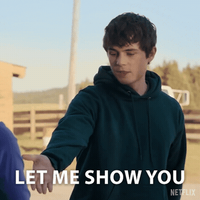 A Man In A Green Hoodie Reaches Out To Shake Someone 'S Hand And Says Let Me Show You GIF