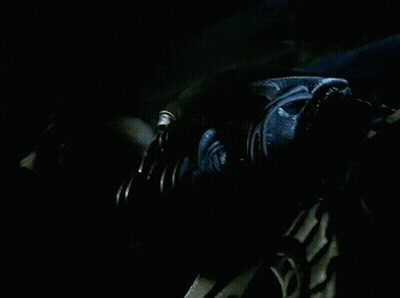 A Man In A Green Jacket Is Being Lifted By Another Man GIF