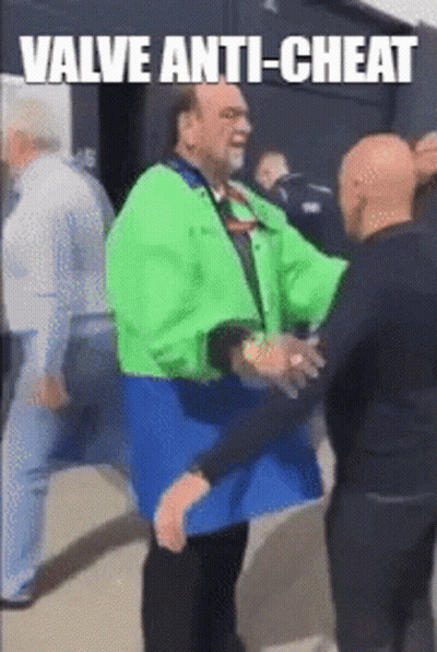 A Man In A Green Jacket Is Hugging Another Man In A Blue Jacket GIF