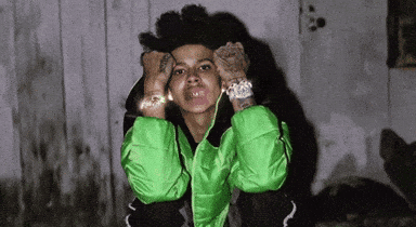 A Man In A Green Jacket Is Making A Face GIF