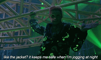 A Man In A Green Jacket Says Like The Jacket It Keeps Me Safe When I M Jogging At Night GIF