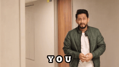 A Man In A Green Jacket Stands In Front Of A Door That Says You On It GIF