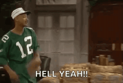 A Man In A Green Jersey Is Standing Next To A Pile Of Logs And Says `` Hell Yeah ! '' GIF