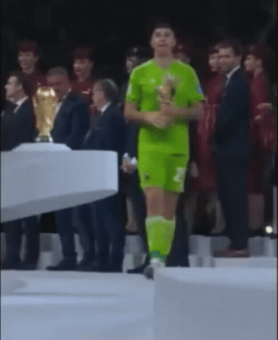A Man In A Green Jersey With The Number 2 On It Is Holding A Trophy GIF