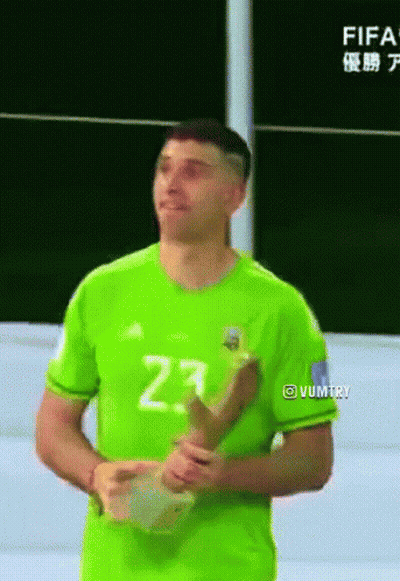 A Man In A Green Jersey With The Number 23 On It Is Holding A Trophy GIF