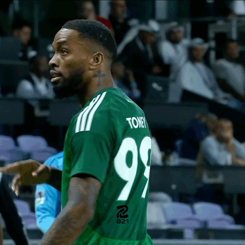 A Man In A Green Jersey With The Number 99 On The Back GIF