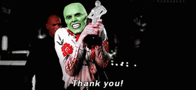 A Man In A Green Mask Is Holding A Trophy And Saying Thank You GIF